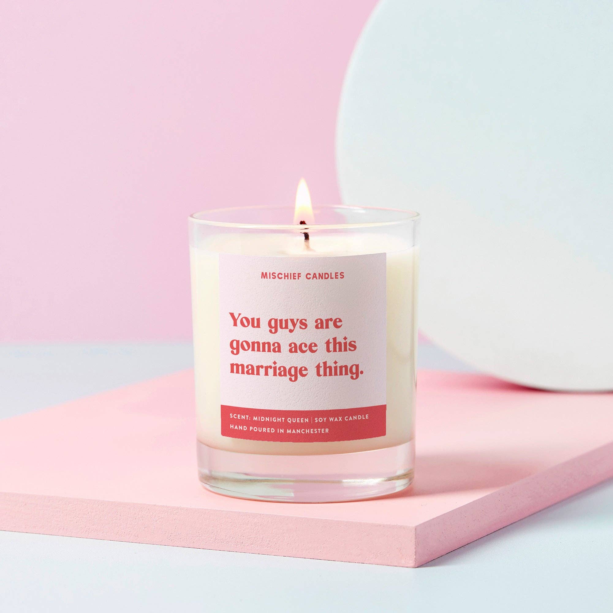 Candle with a printed label saying you guys are going to ace this marriage thing - clear glass jar