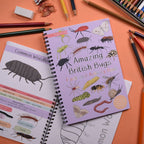Children's activity book on bugs with pencils and crayons on a colorful background