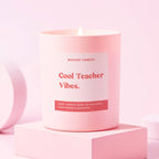 Pink glass jar candle with 'cool teacher vibes' label.