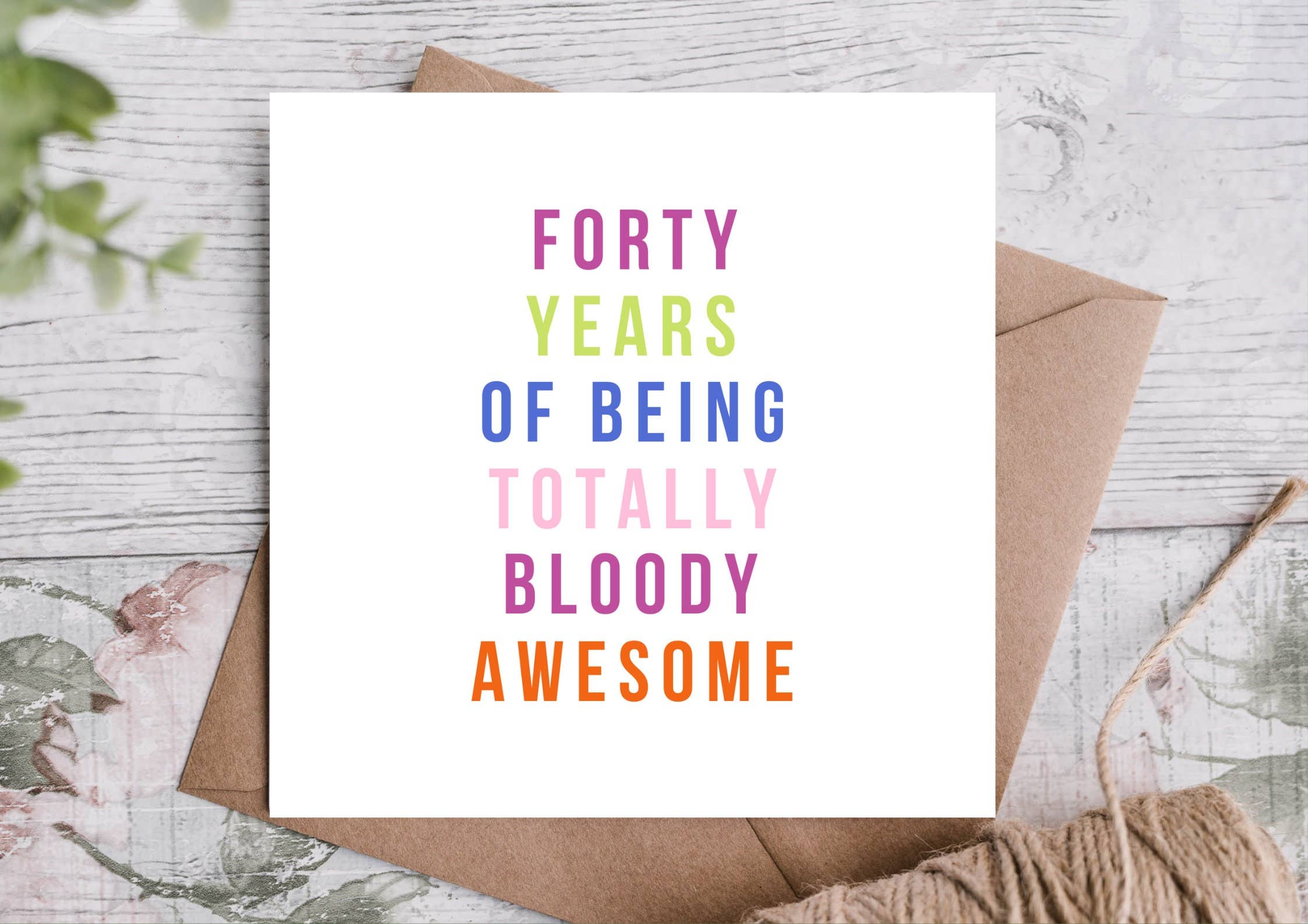 Greeting card with colorful text 'Forty Years of Being Totally Bloody Awesome' with a kraft envelope.