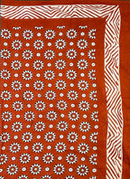 Coggs rust cotton scarf / sarong handprinted with an all over floral pattern.