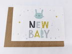 Greeting card with a cat illustration and 'New Baby' text on a white background