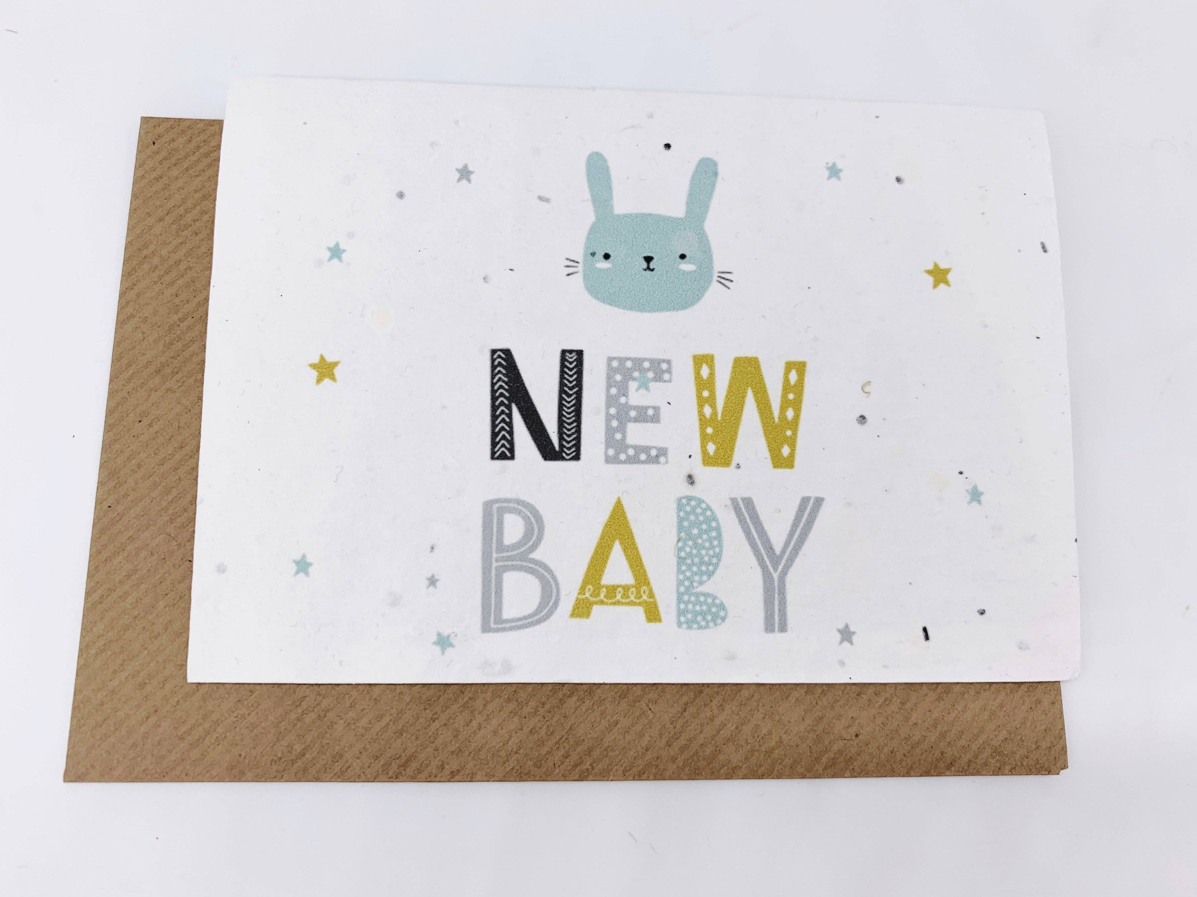 Greeting card with a cat illustration and 'New Baby' text on a white background
