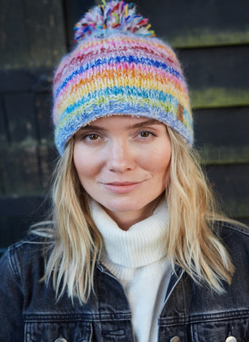 A rainbow striped design with a big pom pom bobble on the top