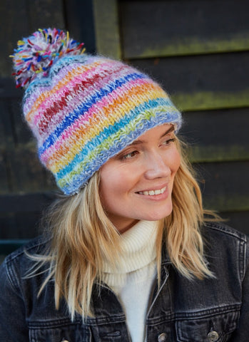 A rainbow striped design with a big pom pom bobble on the top