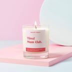 soy wax candle with label 'Tired mum club' in clear glass jar 