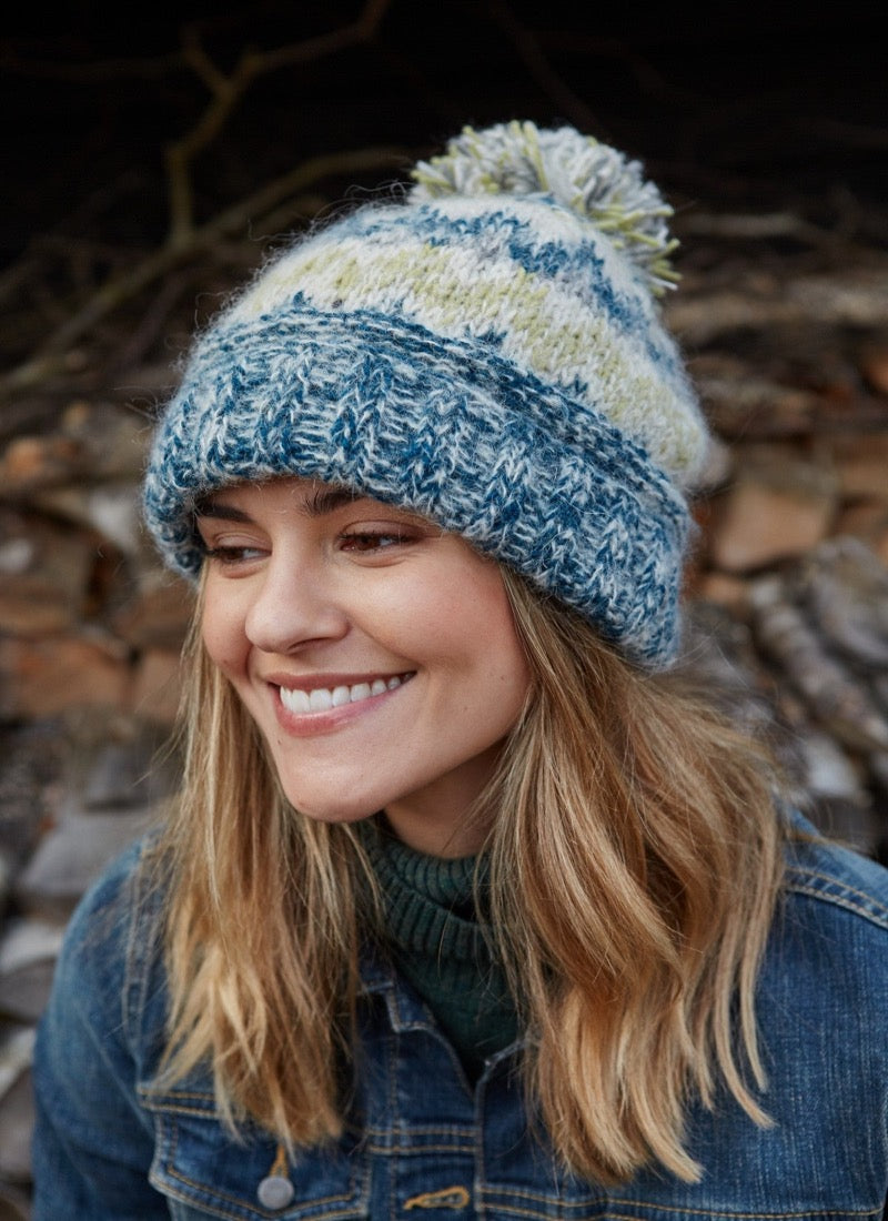 Totnes bobble beanie in a green and blue mix, with a bobble on the top