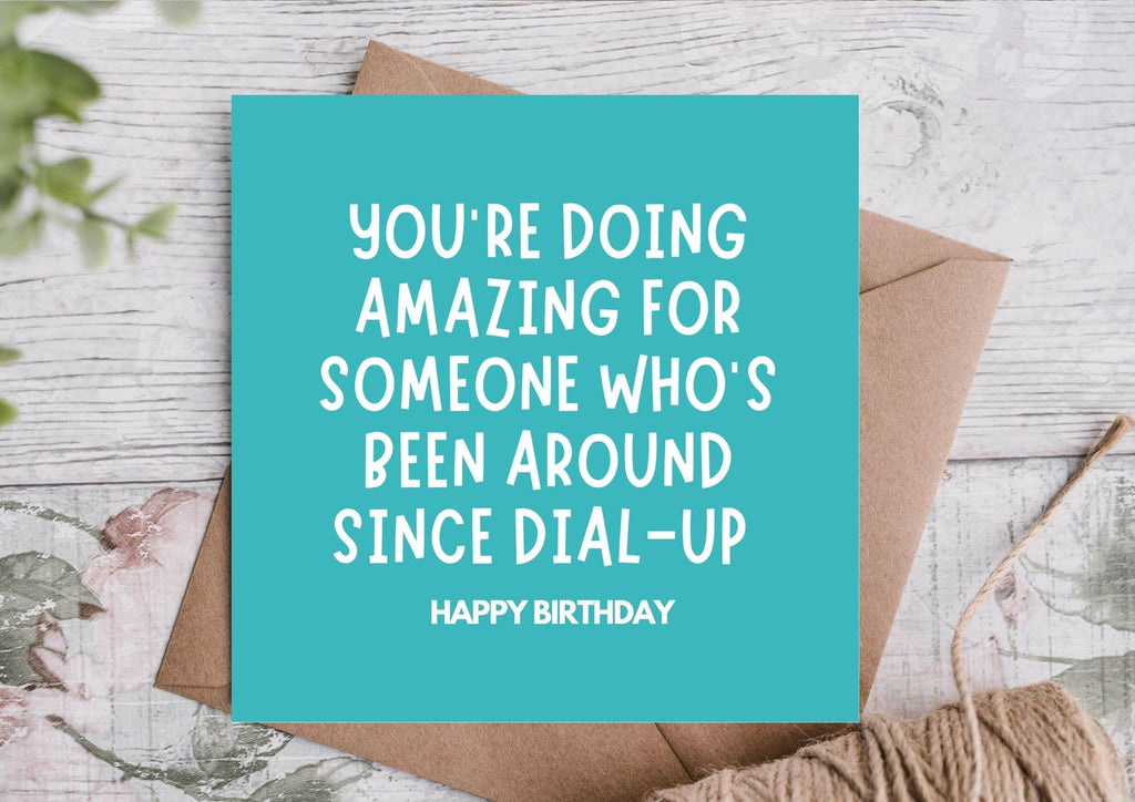Blue birthday card with text on a wooden surface