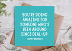 Blue birthday card with text on a wooden surface