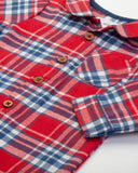 Plaid romper in red blue and white with wooden buttons. 